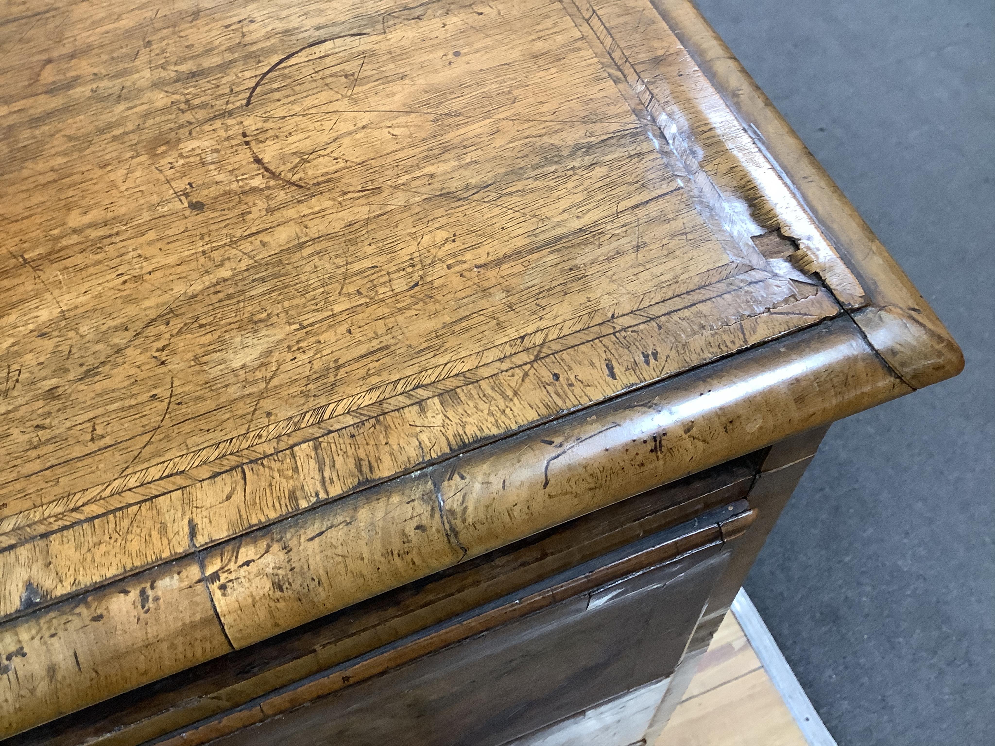 A mid 18th century feather banded walnut concave starburst walnut chest of three drawers, with brushing slide, width 108cm, depth 54cm, height 92cm